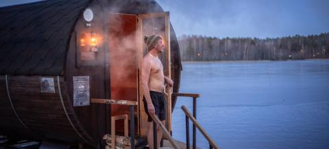Sauna enthusiast outside a barrel sauna at Lake Tohloppi in city of Tampere, the international Sauna Capital of the World