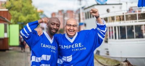 Two international citizens wearing blue Tampere.Finland jerseys at Laukontori