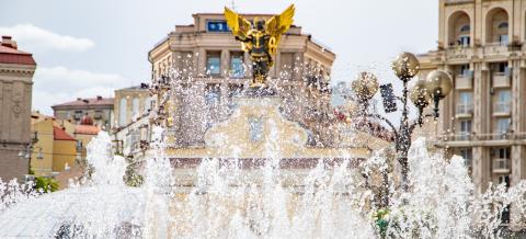 A fountain with a golden center piece in the center of Kyiv.