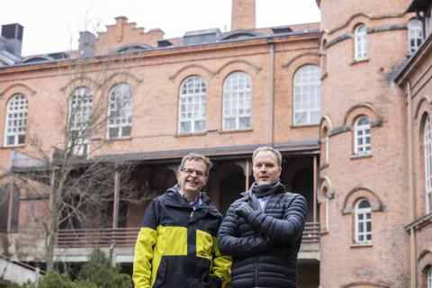 Paikkatietoasiantuntijat seisovat punatiilisen Frenckellin kiinteistön sisäpihalla.