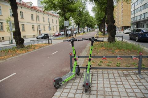 Electric scooters parked by the street.