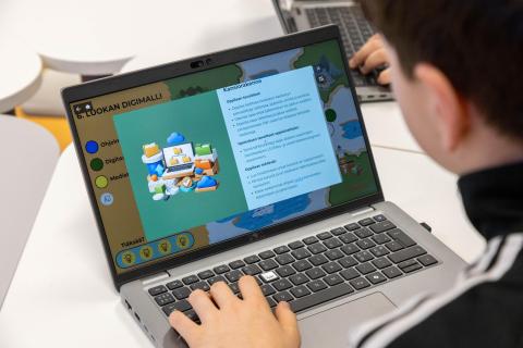 Tomas Sewell, a pupil, plays the Digimalli game for 6th graders on his computer.